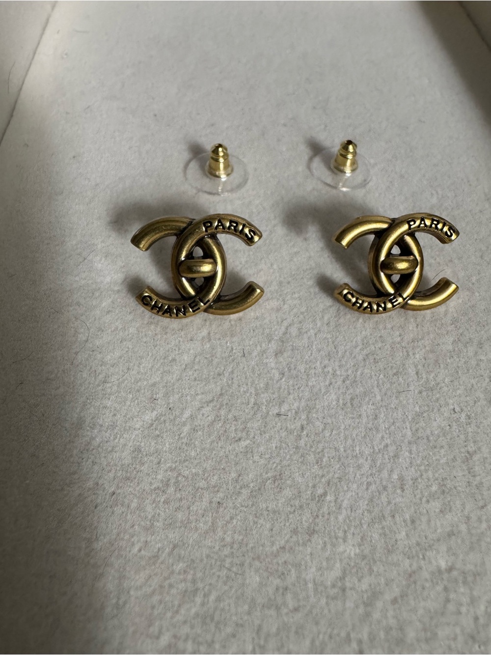 Gold earrings with detailed writing